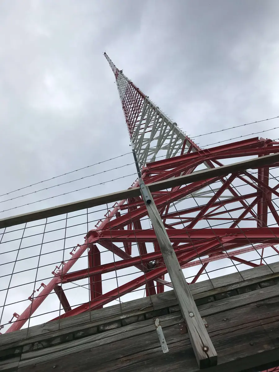 A red and white lattice broadcast tower