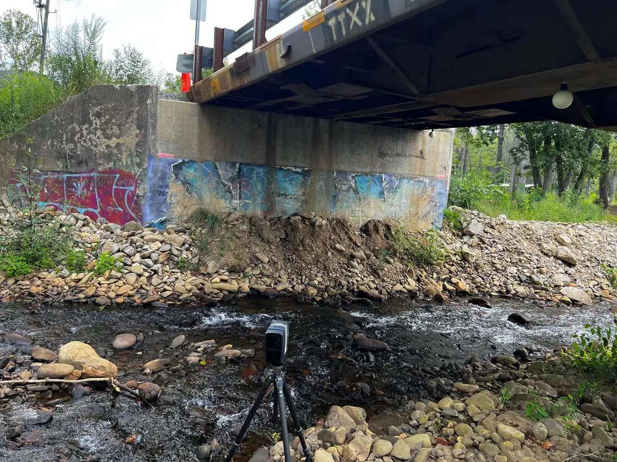 Testing equipment set up beneath a highway bridge