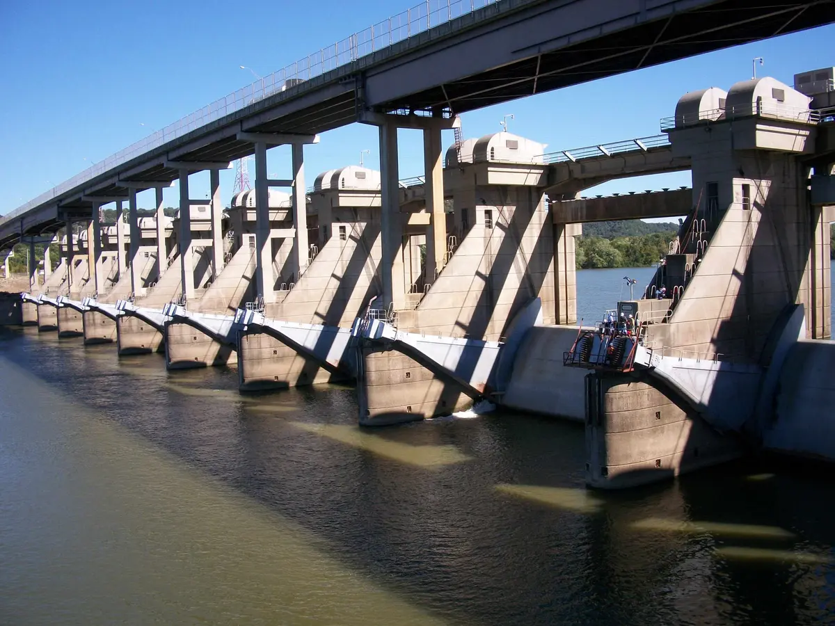 A long concrete dam with Tainter gates across a river